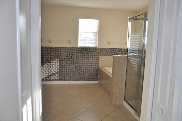 bathroom featuring tile patterned flooring, shower with separate bathtub, and tile walls