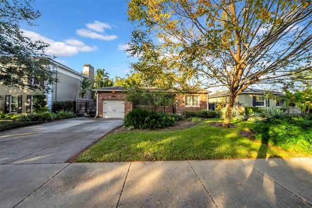 view of front of property featuring a garage and a front lawn