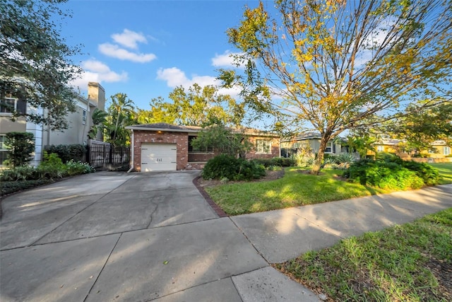 view of front of house with a front yard and a garage