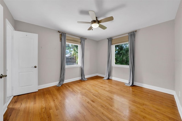 unfurnished room with hardwood / wood-style flooring and ceiling fan