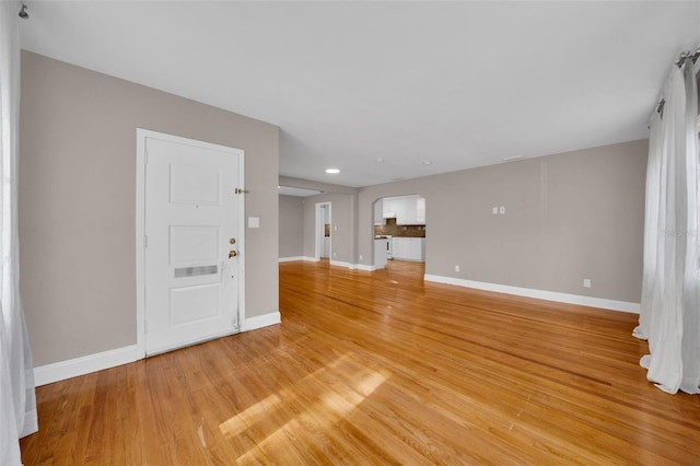 unfurnished living room with light hardwood / wood-style floors