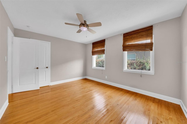 spare room featuring hardwood / wood-style floors and ceiling fan