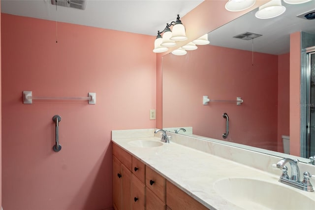 4859 Independence Dr, Bradenton, FL 34210 - bathroom featuring double vanity, toilet, and a shower with door