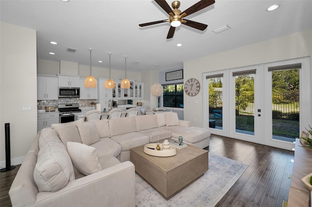 living room with ceiling fan and light wood-type flooring