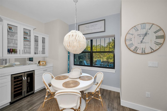 dining space with wine cooler, a chandelier, and dark wood-type flooring