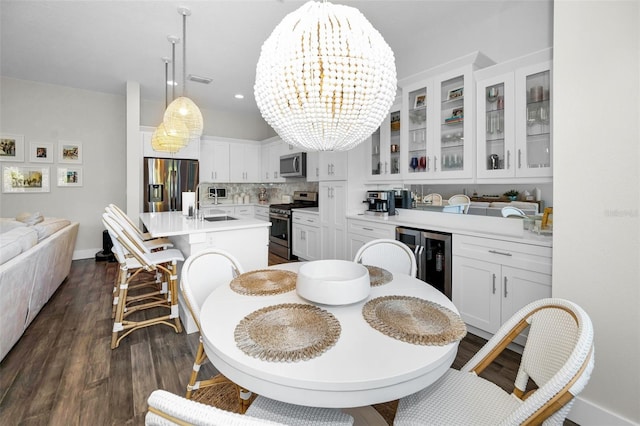 dining room with wine cooler, sink, dark hardwood / wood-style floors, and a notable chandelier