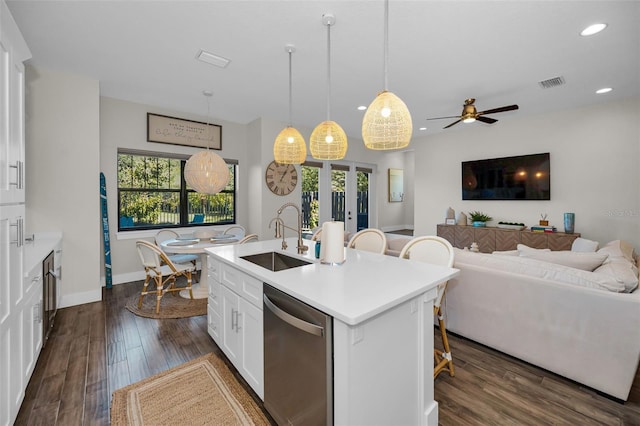 kitchen featuring dishwasher, a kitchen island with sink, white cabinets, sink, and a healthy amount of sunlight