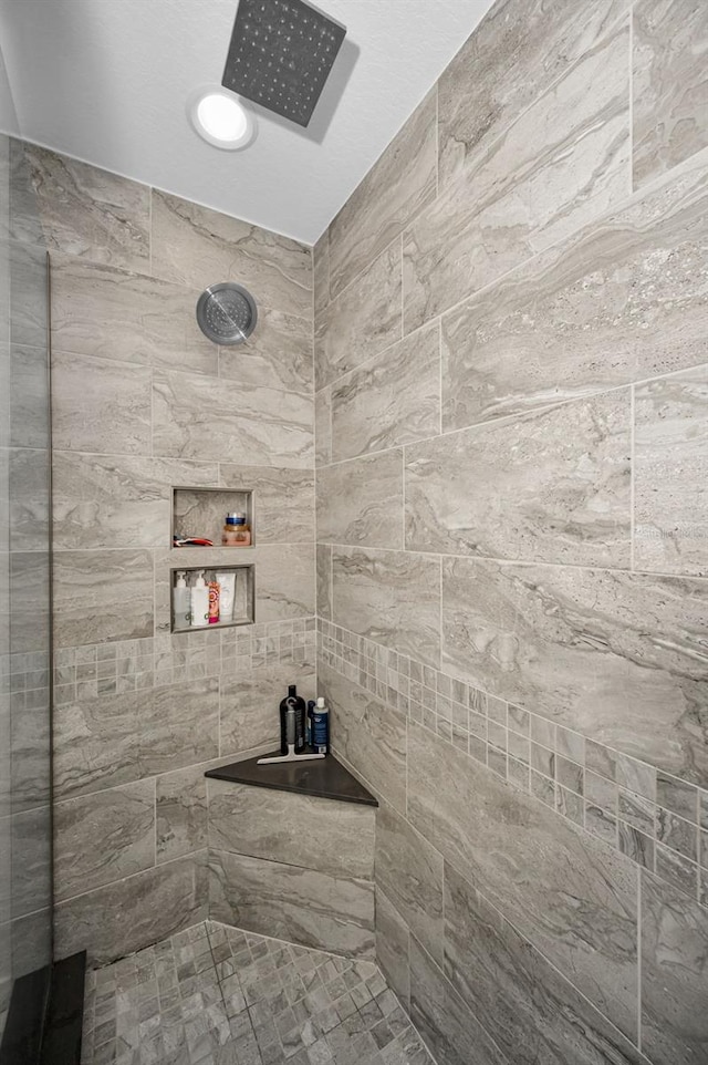 bathroom with tiled shower