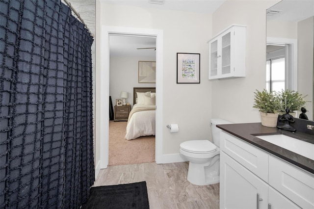 bathroom featuring vanity, toilet, and walk in shower