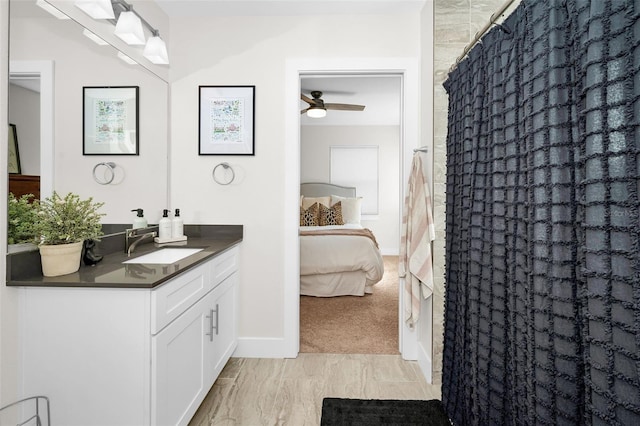 bathroom with vanity, ceiling fan, and curtained shower