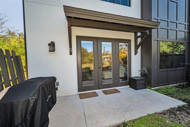 property entrance featuring a patio area and french doors