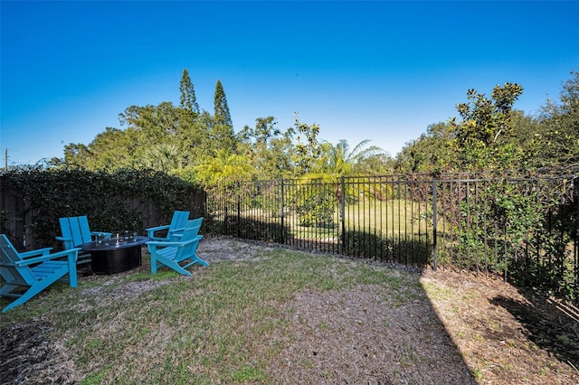 view of yard featuring an outdoor fire pit