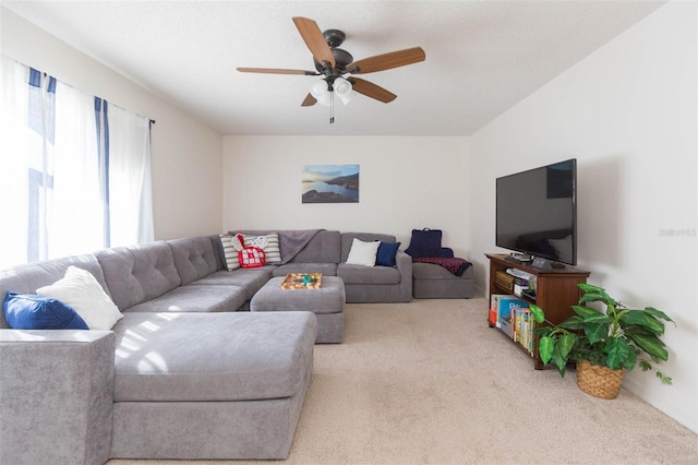 living room featuring light carpet and ceiling fan