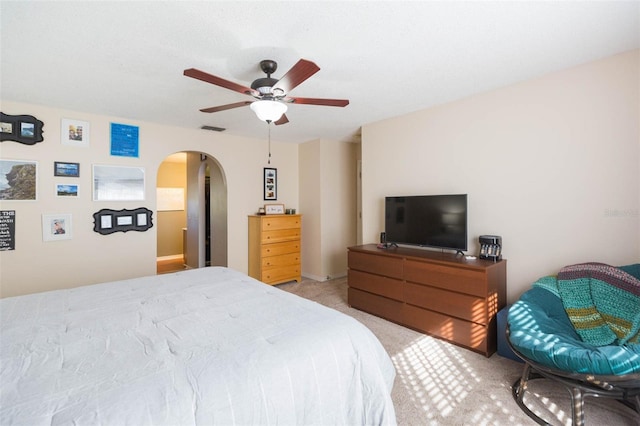 bedroom with ceiling fan and light carpet