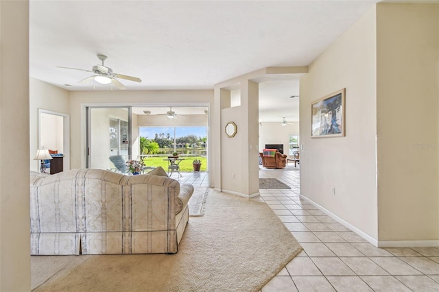 tiled living room with ceiling fan