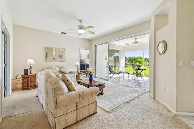 carpeted living room with ceiling fan