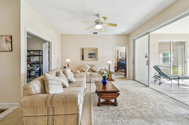 tiled living room featuring ceiling fan