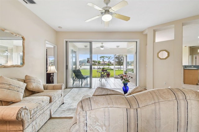 carpeted living room featuring ceiling fan