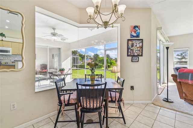 dining area featuring a wealth of natural light, light tile patterned floors, and ceiling fan with notable chandelier