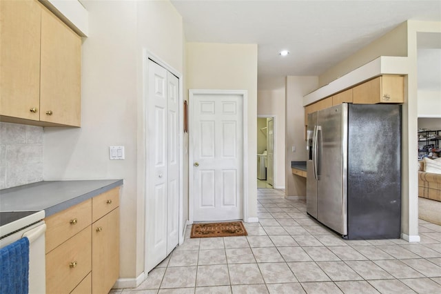 kitchen with stainless steel fridge with ice dispenser, light brown cabinets, tasteful backsplash, and light tile patterned flooring