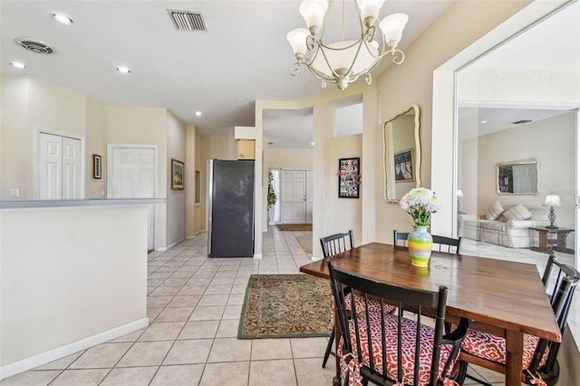 dining room featuring light tile patterned floors and a notable chandelier