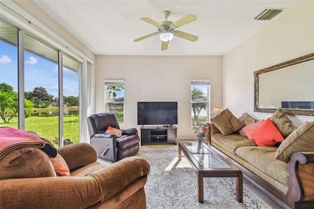 living room with ceiling fan and a healthy amount of sunlight