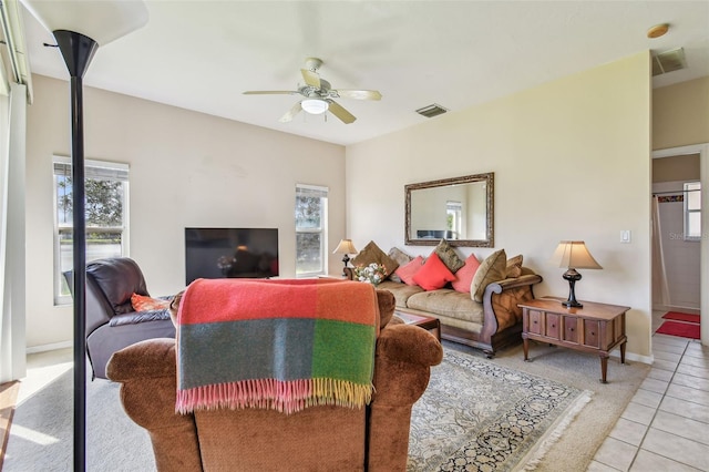 tiled living room with ceiling fan