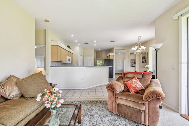 living room featuring an inviting chandelier and light tile patterned flooring