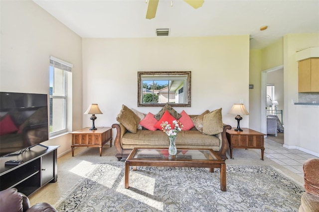 tiled living room with ceiling fan