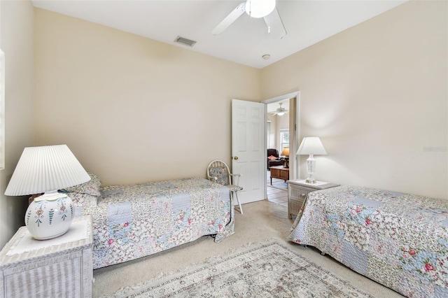 bedroom featuring light carpet and ceiling fan