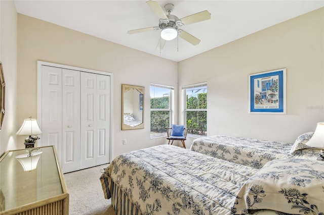 carpeted bedroom featuring ceiling fan and a closet