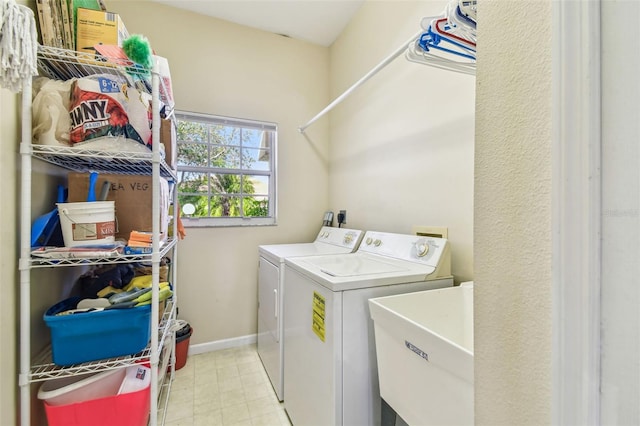 clothes washing area with sink and washing machine and clothes dryer