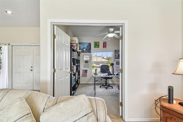 office space with light colored carpet and ceiling fan