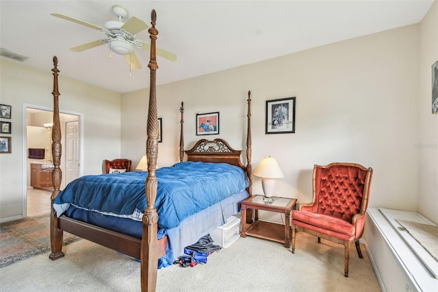 bedroom featuring ensuite bath, ceiling fan, and light carpet