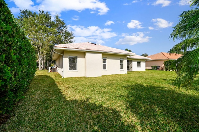 rear view of property with a lawn