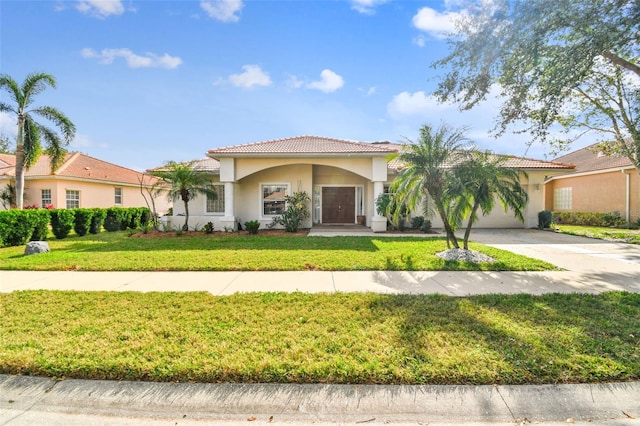 mediterranean / spanish house with a front yard