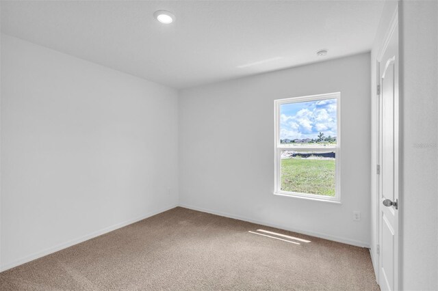 13 Prince Anthony Ln, Palm Coast, FL 32164 - spare room featuring carpet flooring, baseboards, and recessed lighting