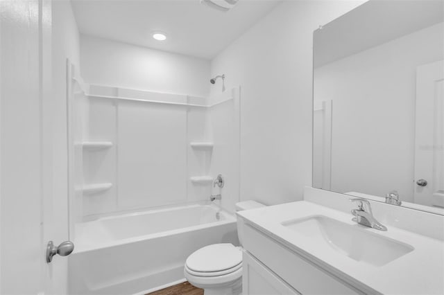 full bathroom featuring toilet, vanity, and washtub / shower combination