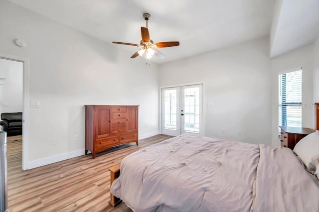 bedroom featuring access to outside, multiple windows, ceiling fan, and french doors