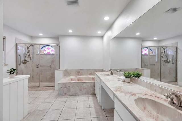 bathroom with plus walk in shower, vanity, and tile patterned floors