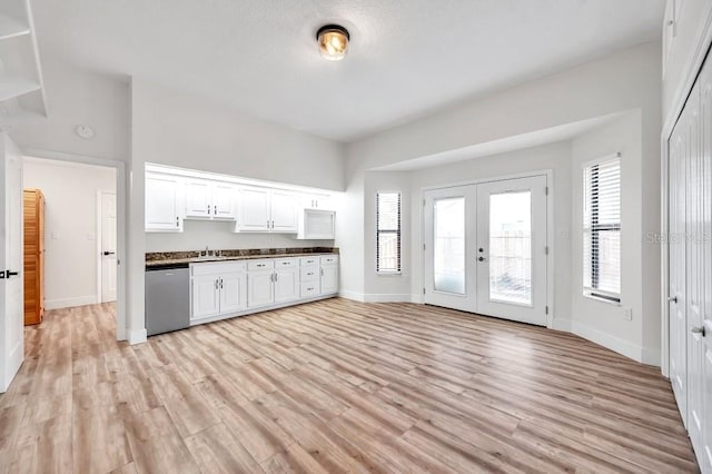 kitchen featuring dishwasher, french doors, sink, light hardwood / wood-style flooring, and white cabinets