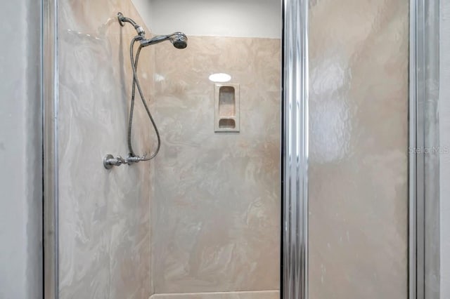 bathroom featuring a shower with door