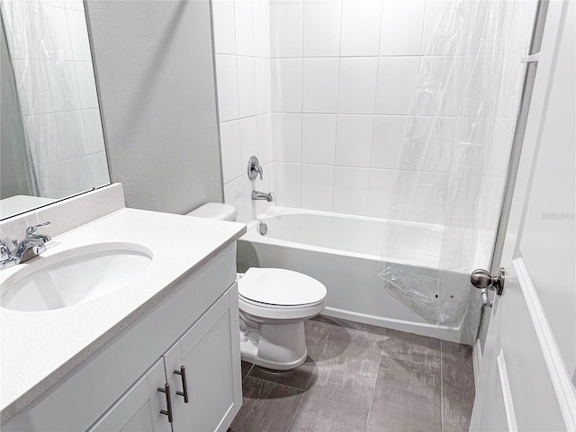 full bathroom with tiled shower / bath combo, toilet, and vanity