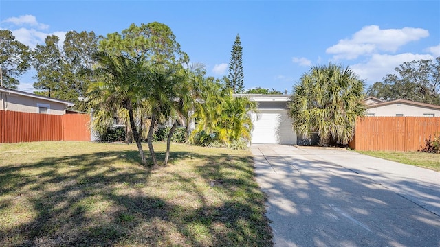 view of front of house featuring a garage and a front yard