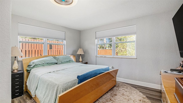 bedroom with dark hardwood / wood-style flooring