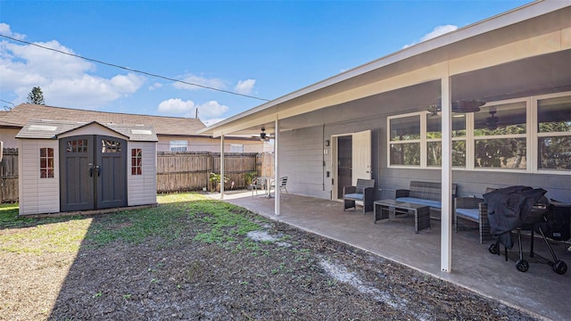 view of yard featuring ceiling fan, a patio, and a shed