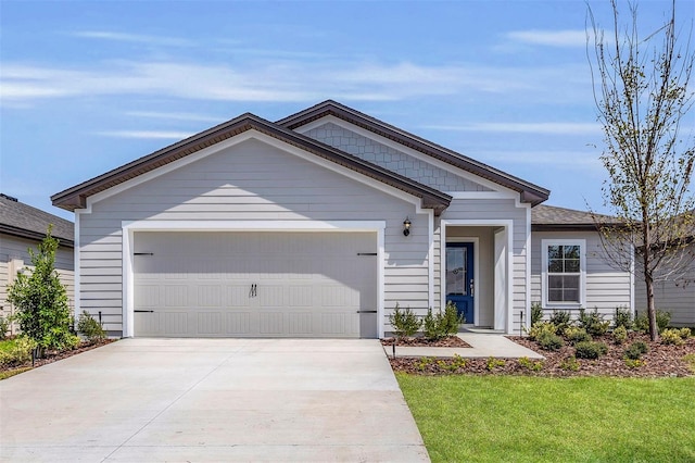 view of front of home featuring a front yard and a garage