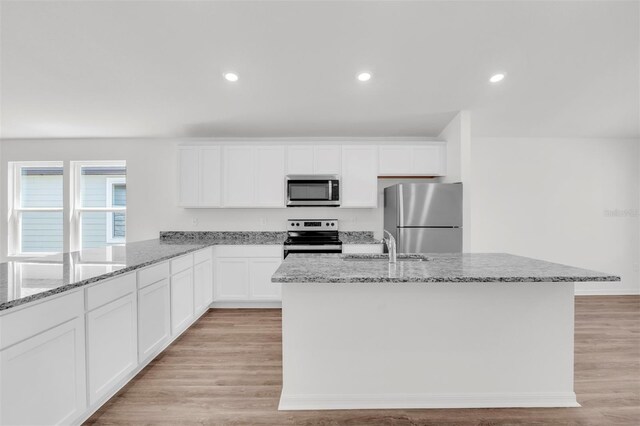 11 Prince Anthony Ln, Palm Coast, FL 32164 - kitchen with stainless steel appliances, a sink, light stone countertops, white cabinets, and recessed lighting