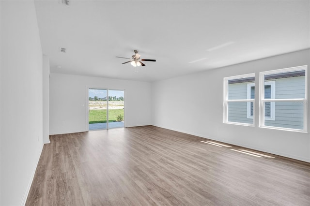 unfurnished room with ceiling fan and wood-type flooring