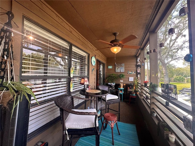 wooden terrace featuring covered porch and ceiling fan